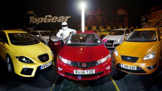 The Stig posing with a collection of hot hatchbacks.